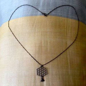 Delicate bee and honeycomb necklace.